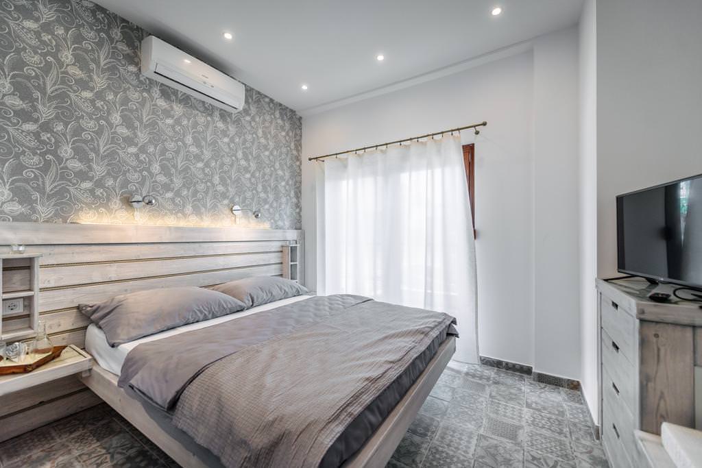 белые шторы в дизайне спальни с серыми обоями