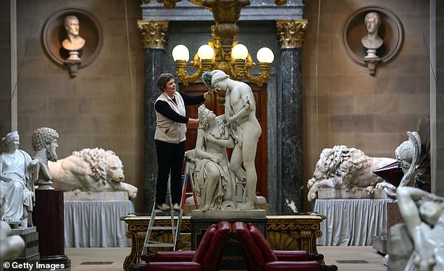 Housemaid Kath Watts poses during her cleaning routine as she spring cleans the Sculpture Gallery in the magnificent Chatsworth House. It takes a team of housemaids to clean the house in preparation for visitors